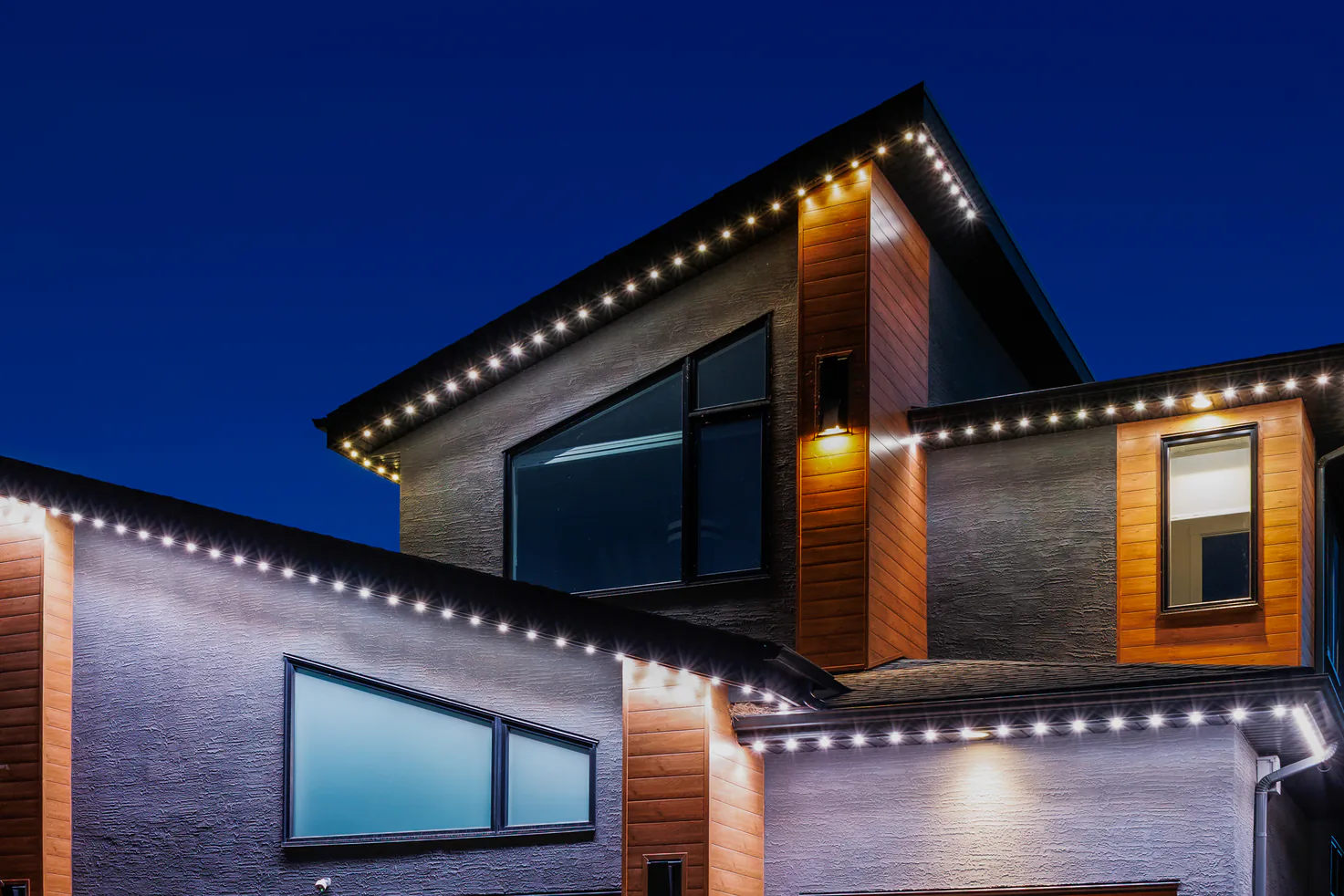 Roofline lights on a home with individual lights picked out in different colors