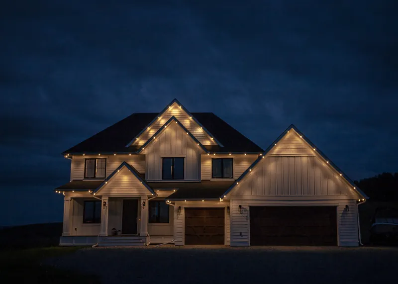 Warm white on twin gables against a night sky