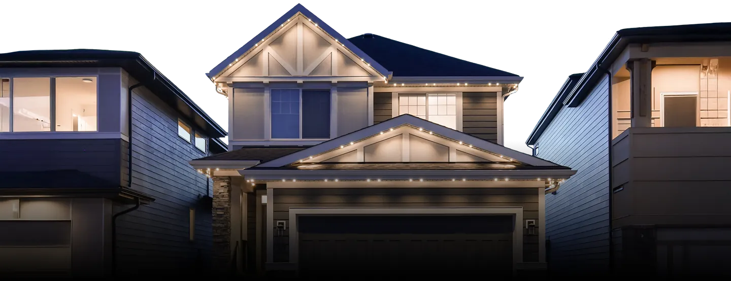 Homes lit with permanent architectural lighting at night