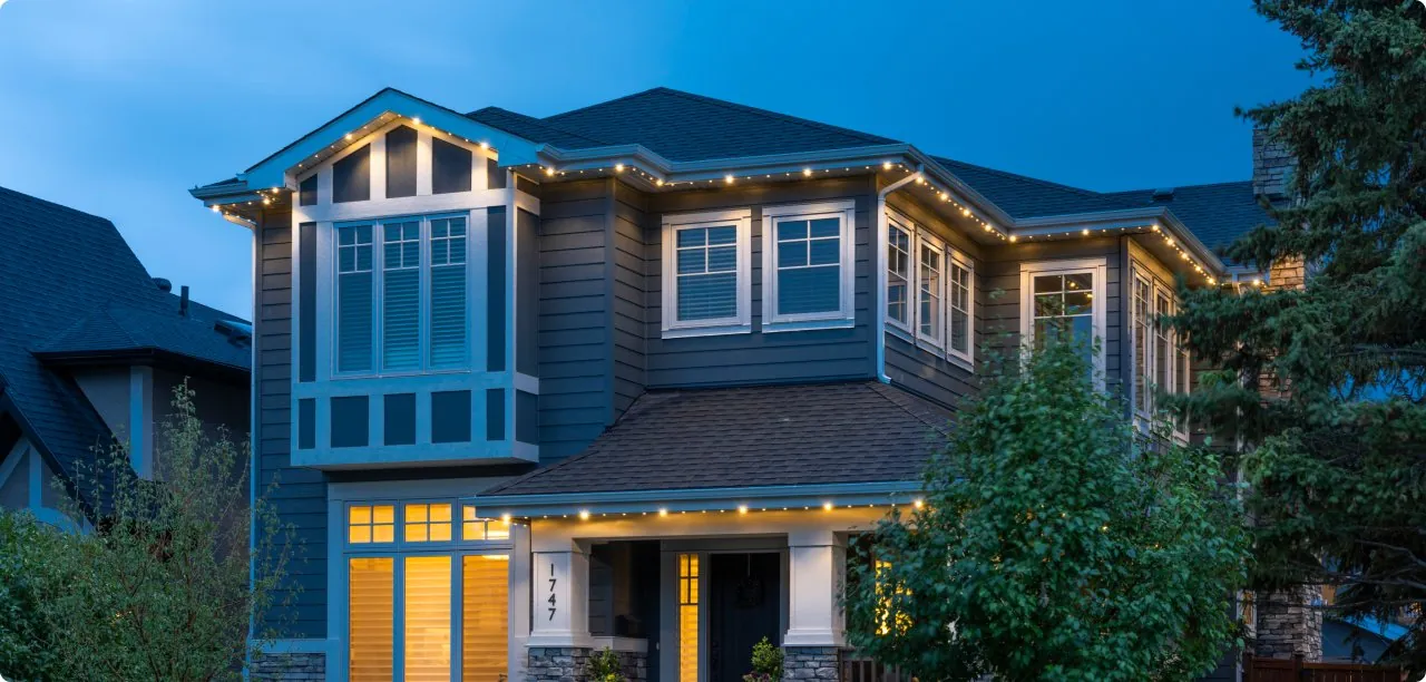 Home lit with warm architectural accent lighting
