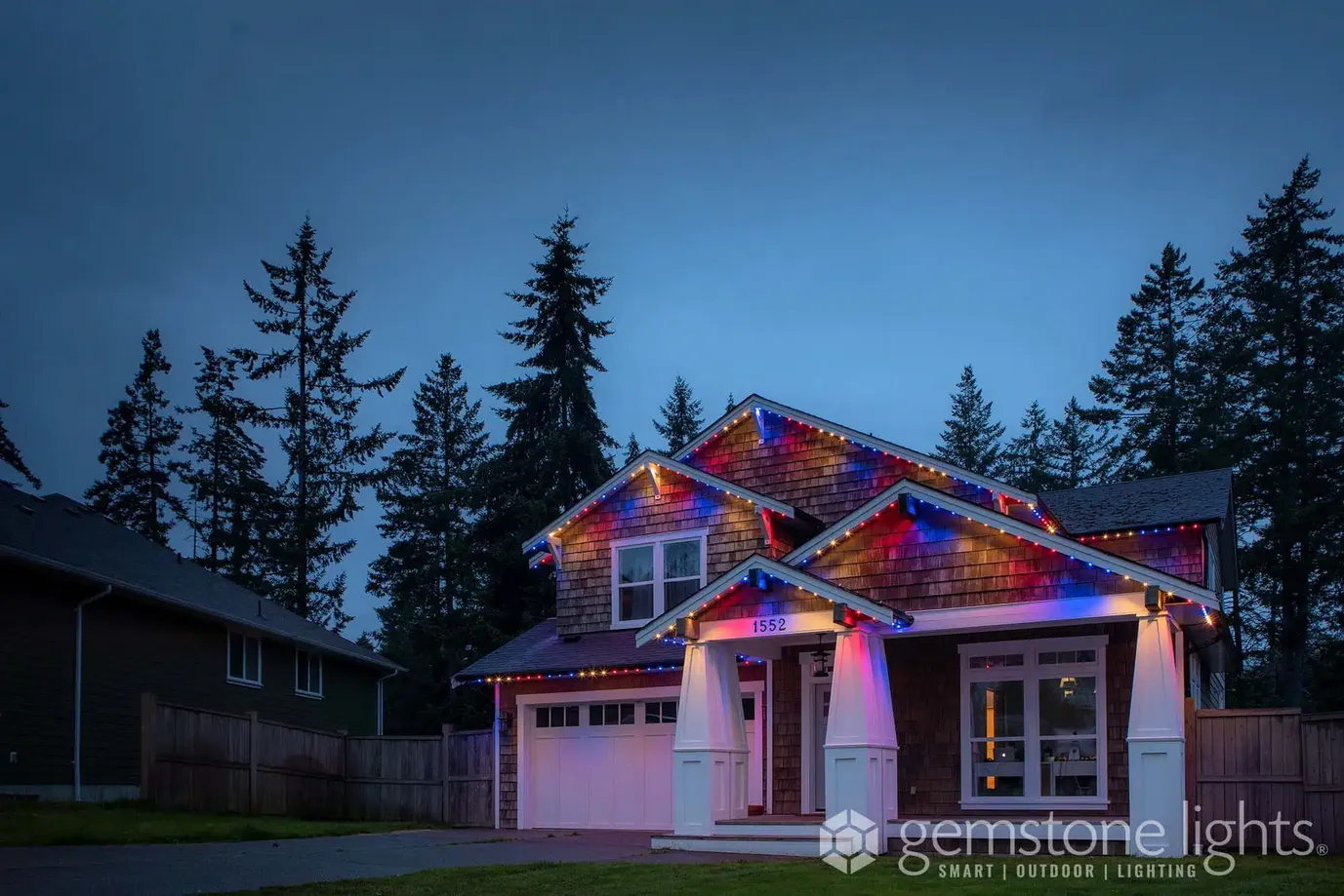 Craftsman home in red, white and blue lights
